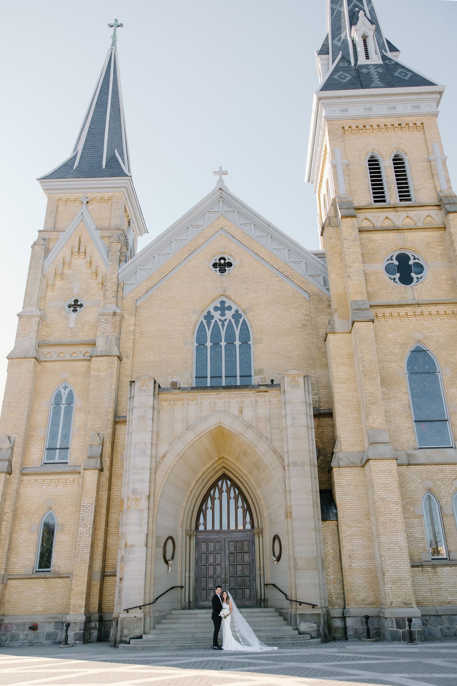 Series of exterior shots showing a grand Gothic revival church with twin spires against bright sky.
