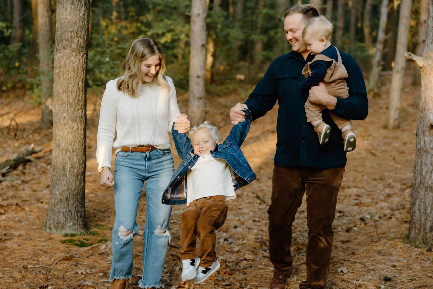 Casual family lifestyle photography session in a peaceful forest setting.