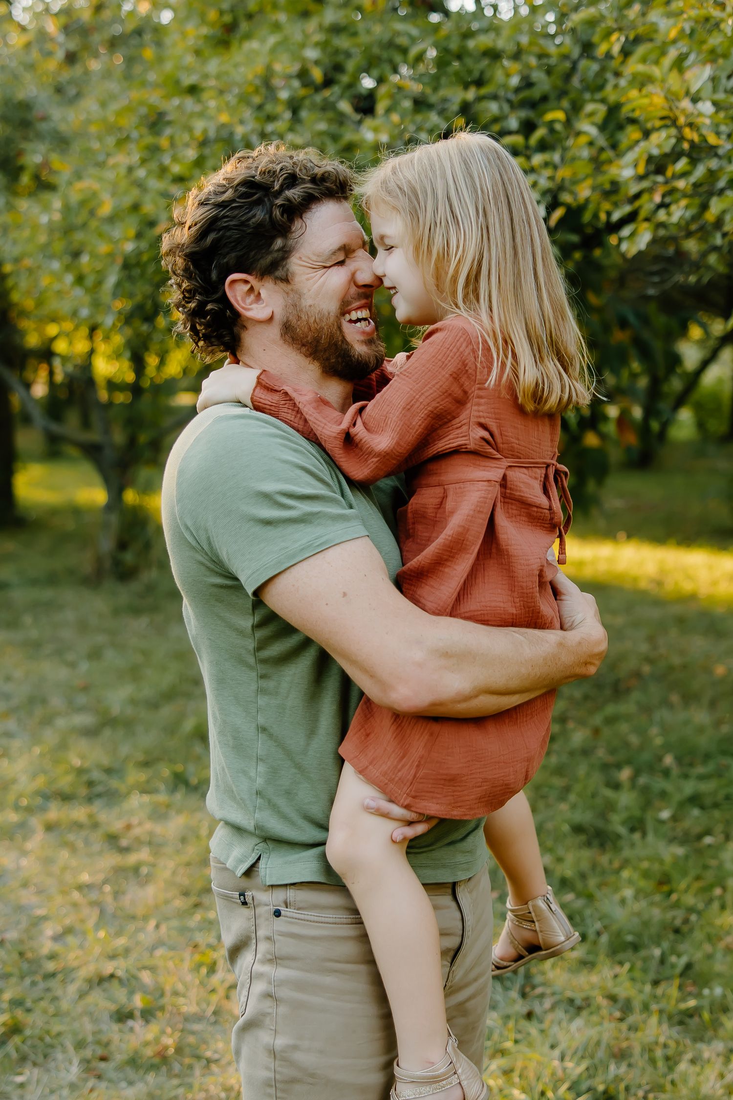 Sweet embrace between loved ones sharing joyful moments in a park during golden hour.