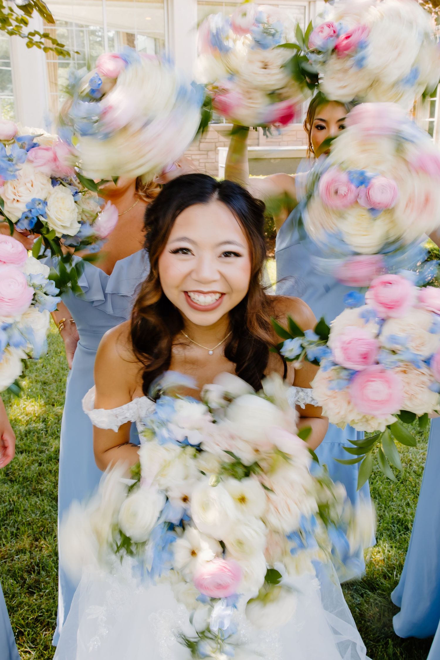 Bridal bouquet with soft pink and white flowers creating a dreamy motion blur effect.