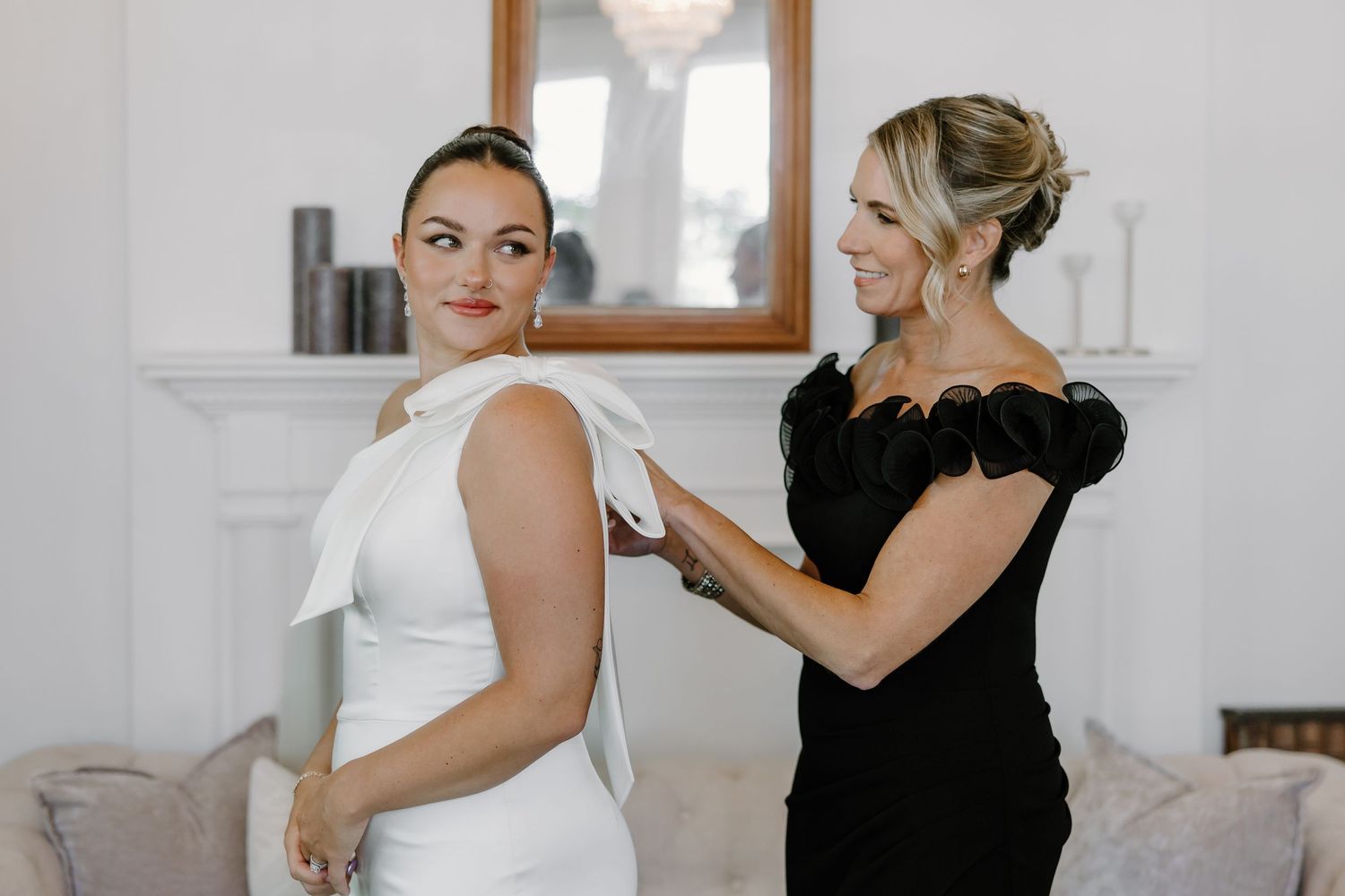 Wedding preparation scene with elegant white dress being fitted.