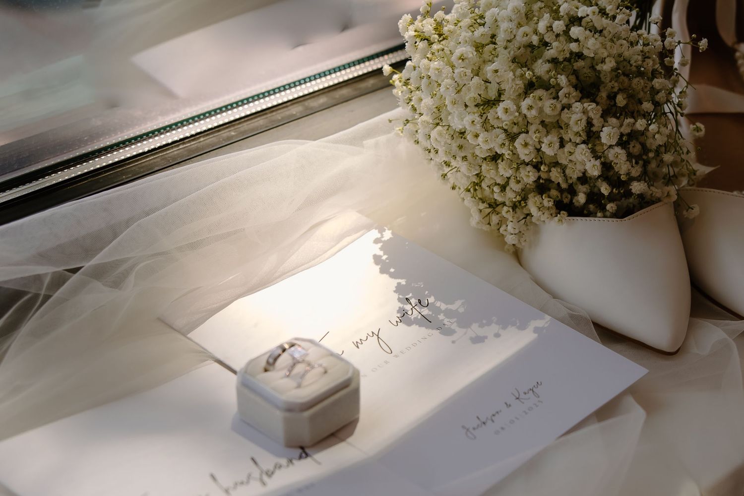 Wedding details featuring delicate baby's breath flowers and elegant stationery.