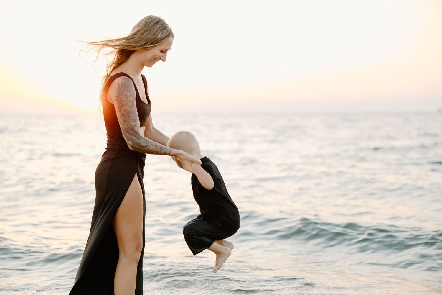 Joyful interaction between people at the beach during a beautiful sunset.