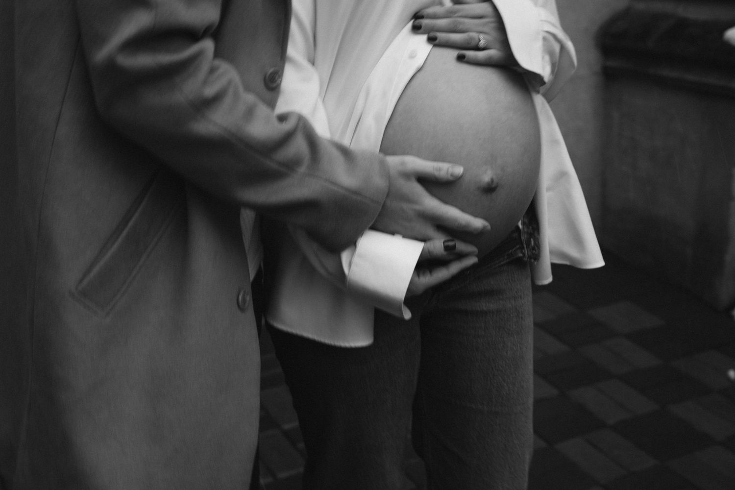 Black and white photo of hands holding ultrasound images.