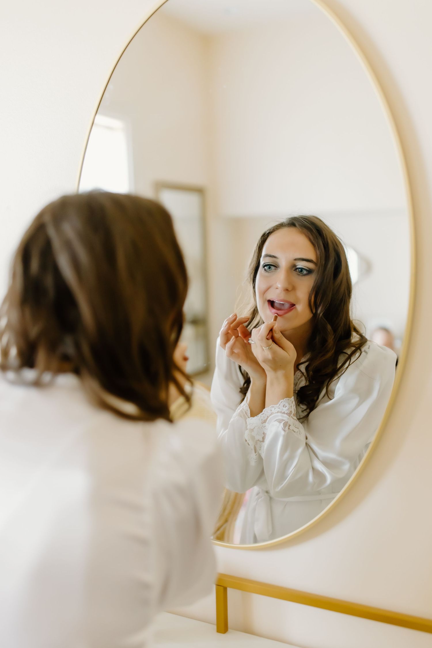 A series of mirror reflections showing joyful moments during wedding preparations.