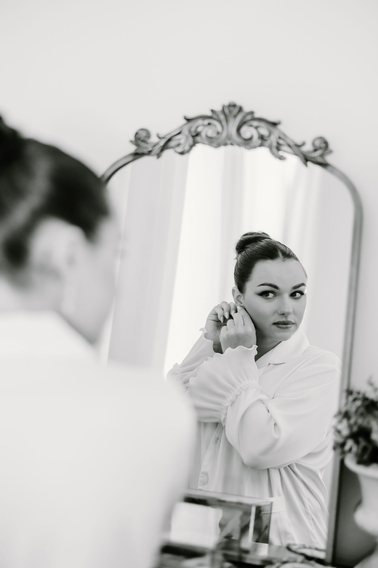 Black and white portrait series showing elegant poses near an ornate mirror.