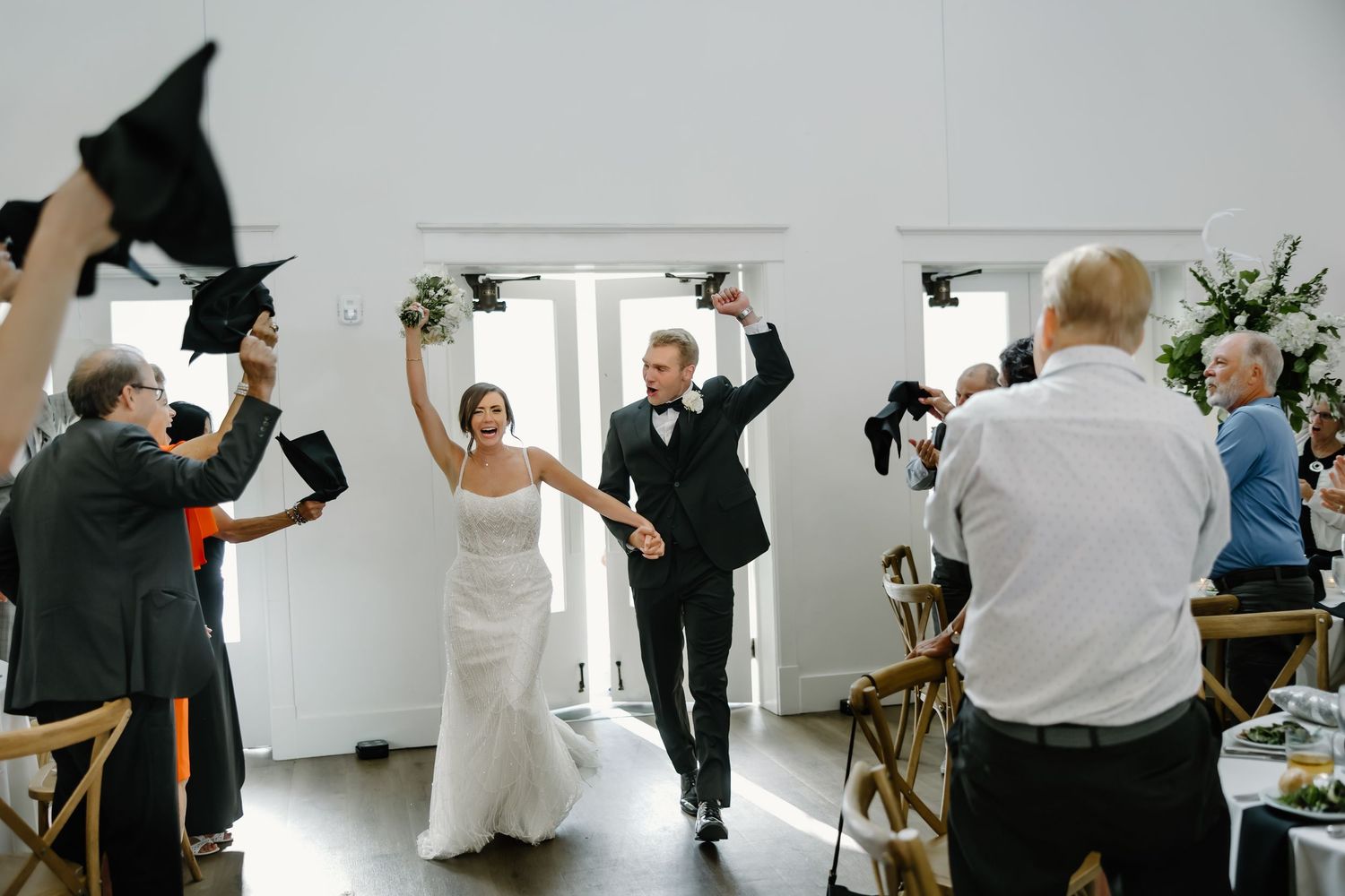Wedding reception venue with white walls and guests mingling during the celebration.