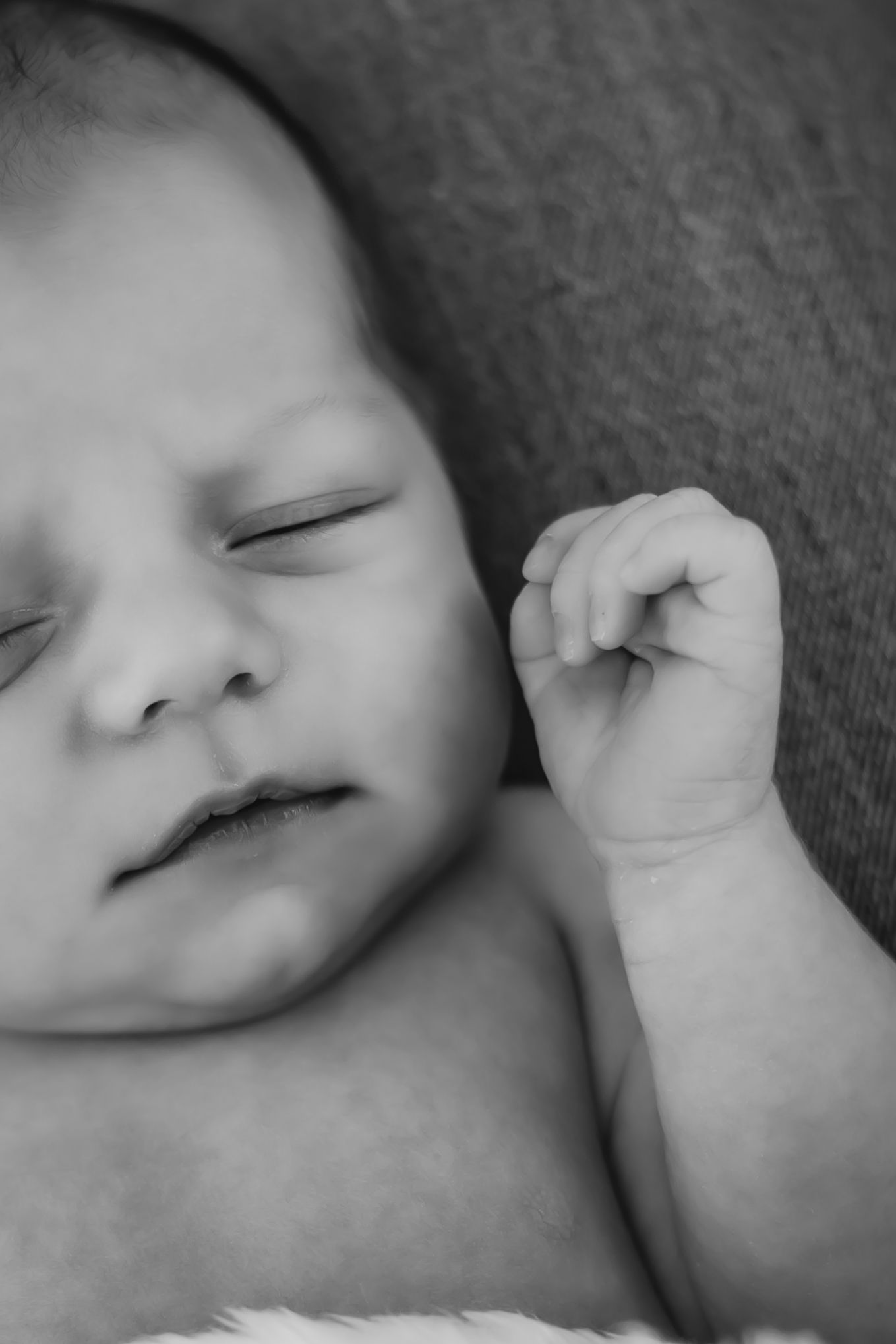 Close-up black and white images of a sleeping baby's peaceful face.