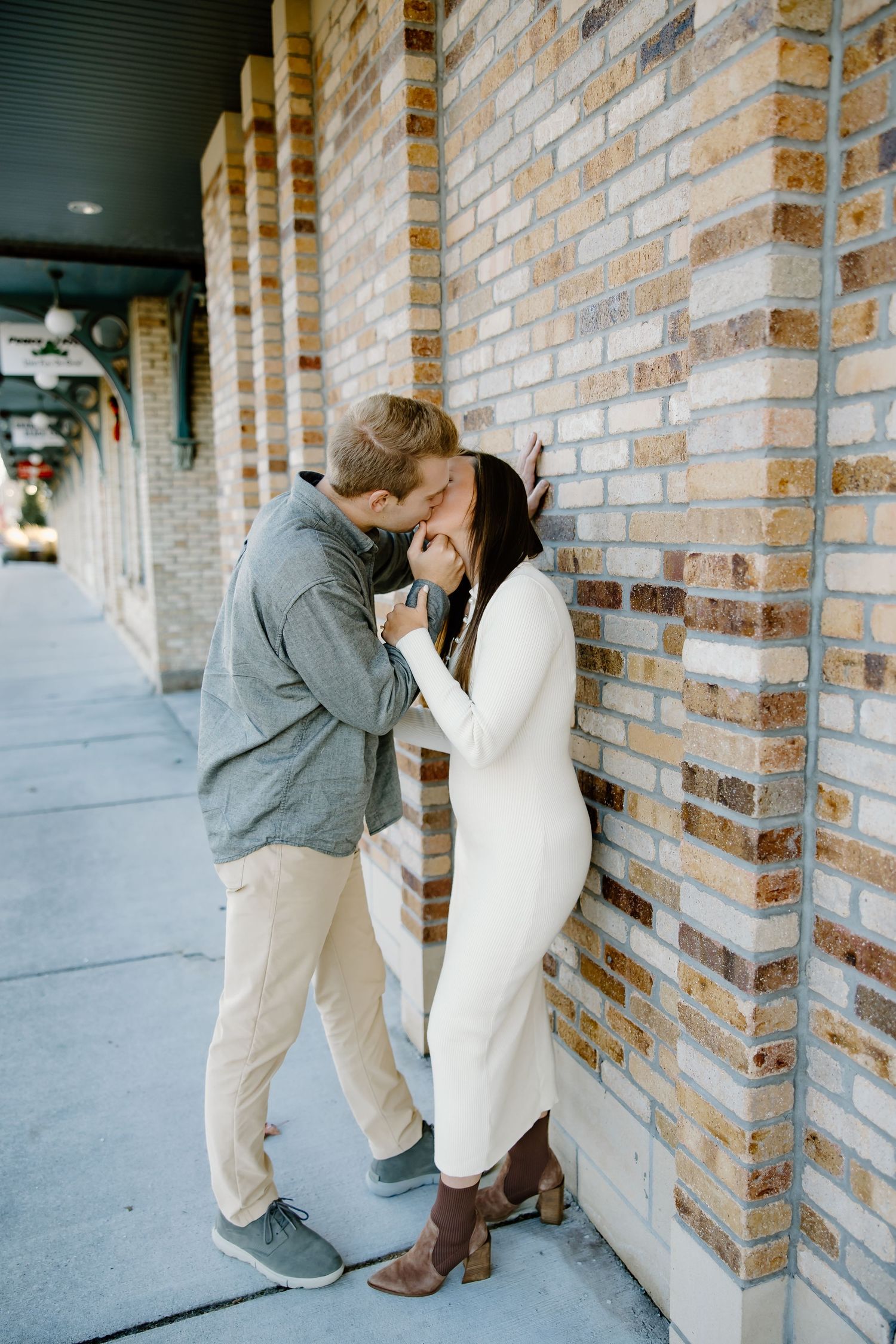 Romantic winter scene against brick wall exterior.