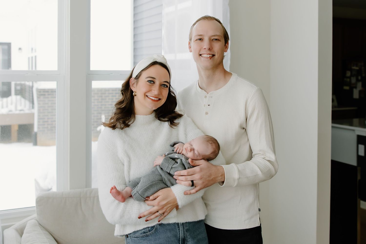 Family portrait series in a bright white room with natural lighting.