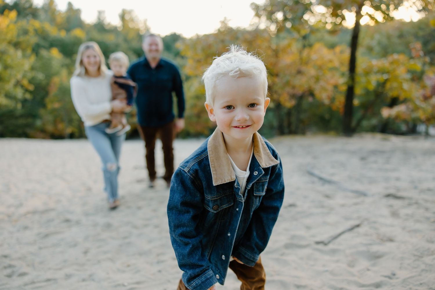 Candid family photography session in natural outdoor setting during autumn.