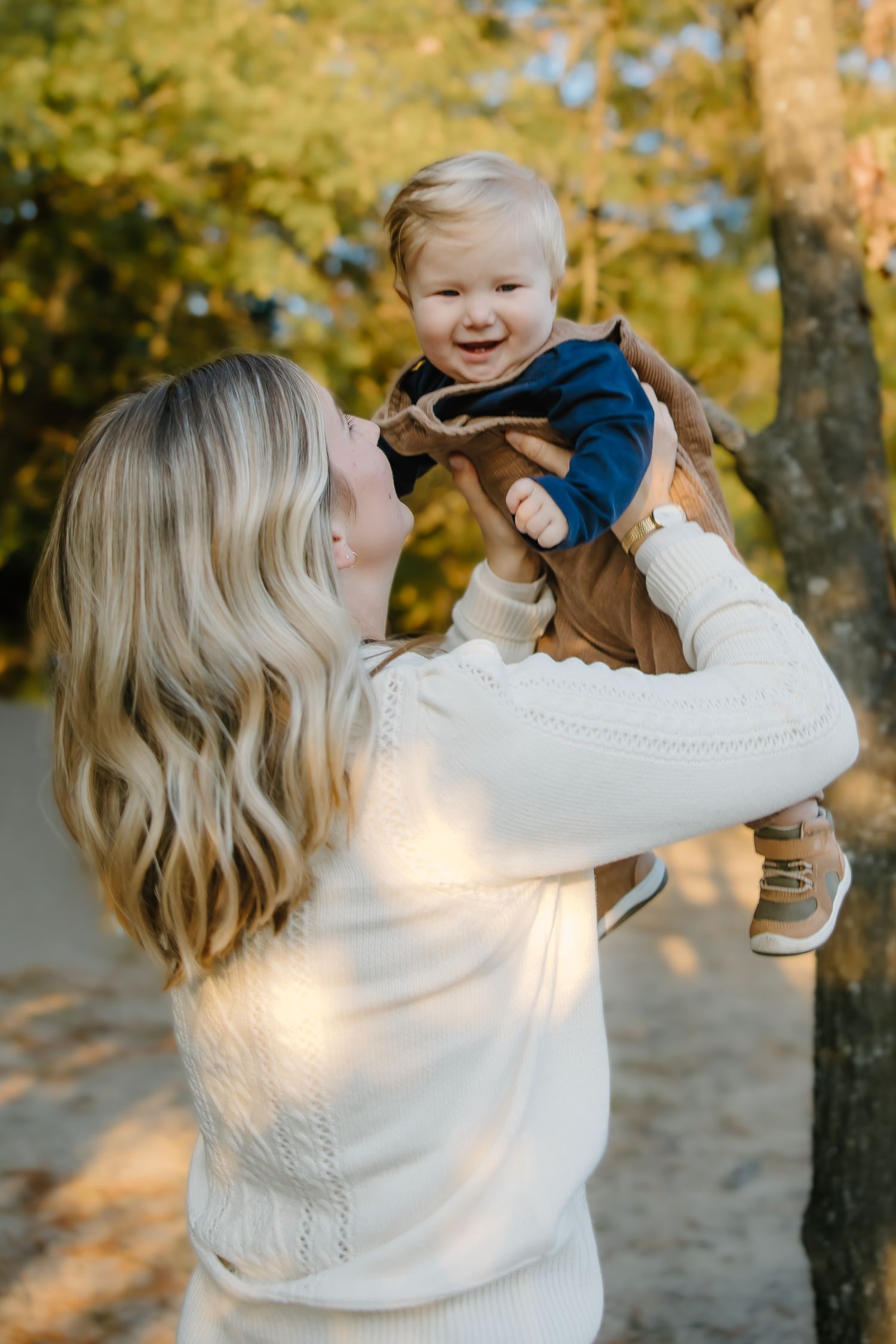 Family shares playful moments during outdoor autumn photography session.
