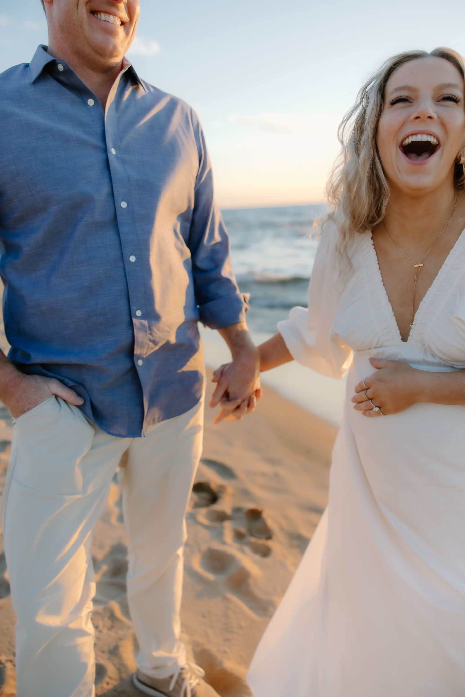 Joyful candid moments captured during a sunset beach photoshoot.