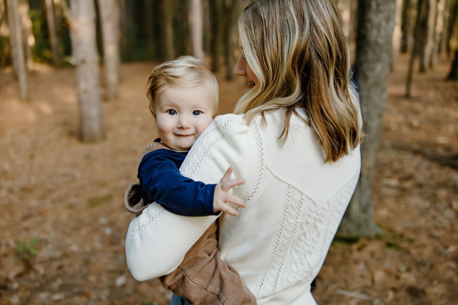 Intimate family moments captured during a professional photoshoot in the woods.
