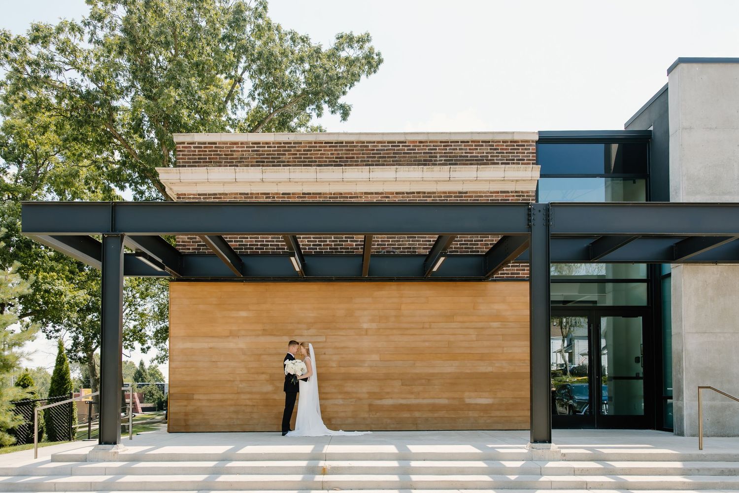 Modern architectural building exterior with wood paneling and clean geometric lines.