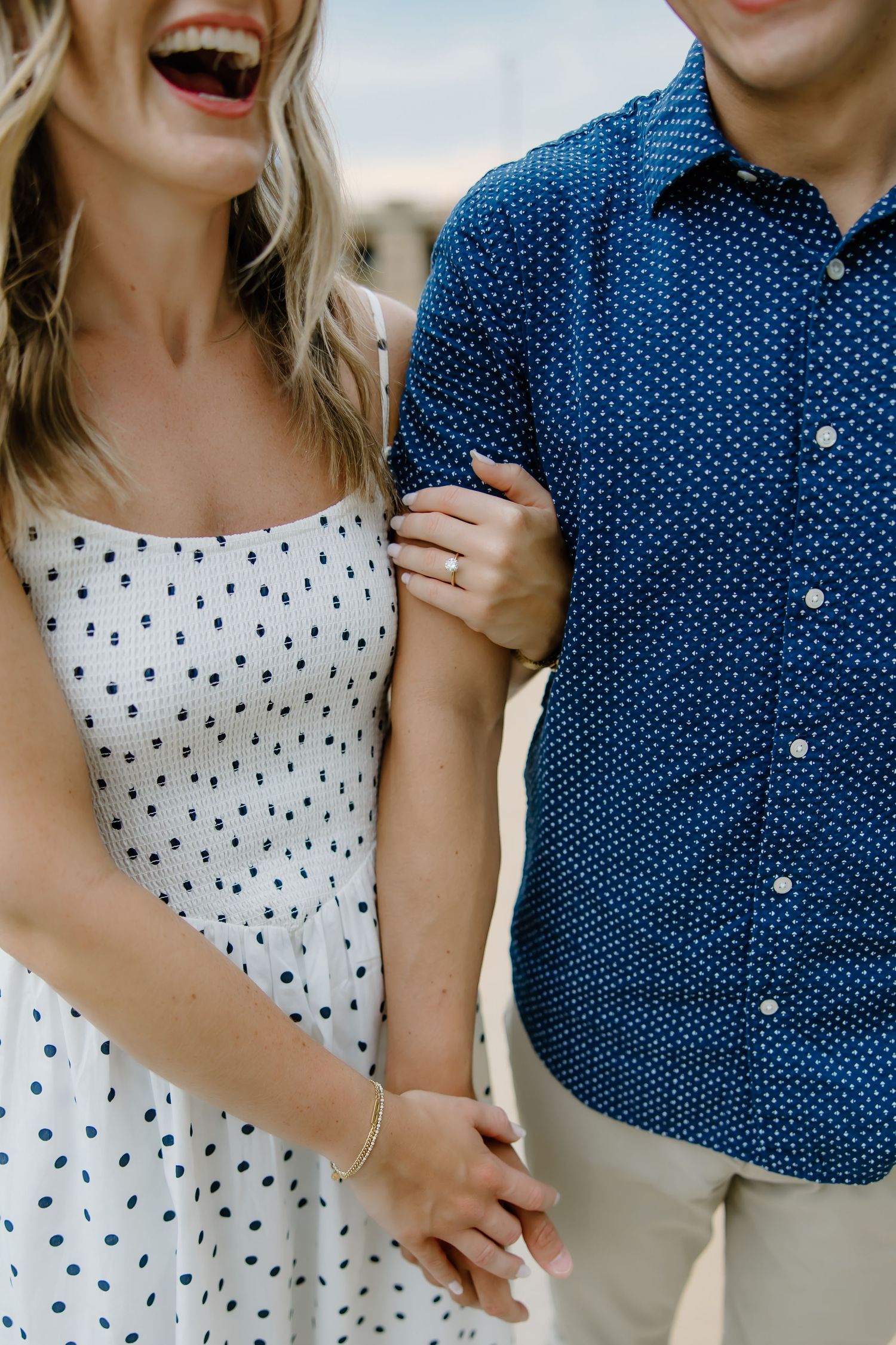 Close-up shots of a couple laughing and embracing in blue and white polka dot outfits.