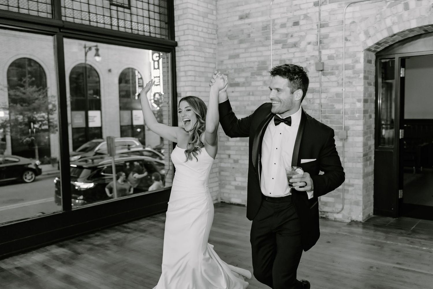 Black and white sequence of dancing in an industrial-style venue.