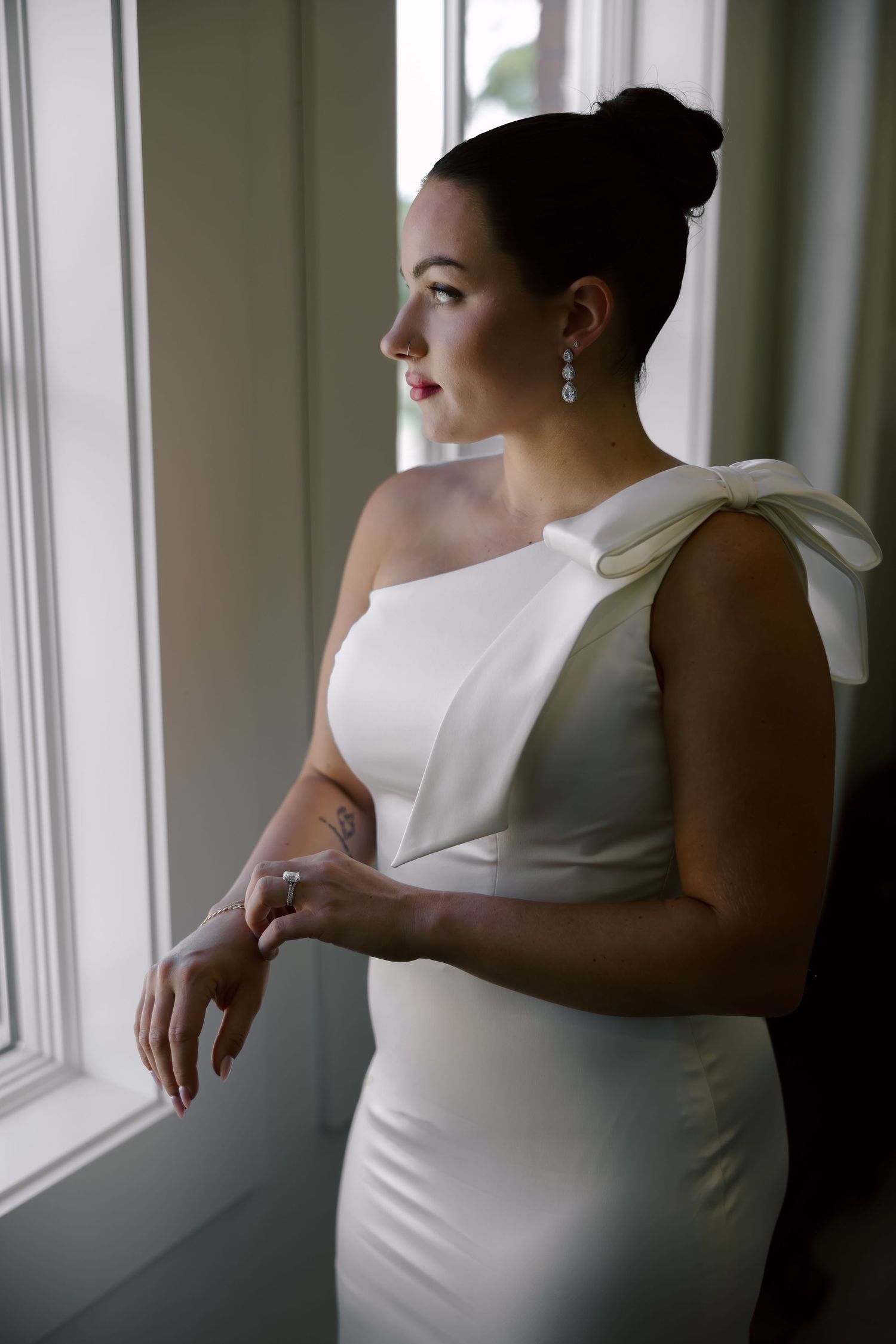 Artistic series of silhouettes in white dress by window light.