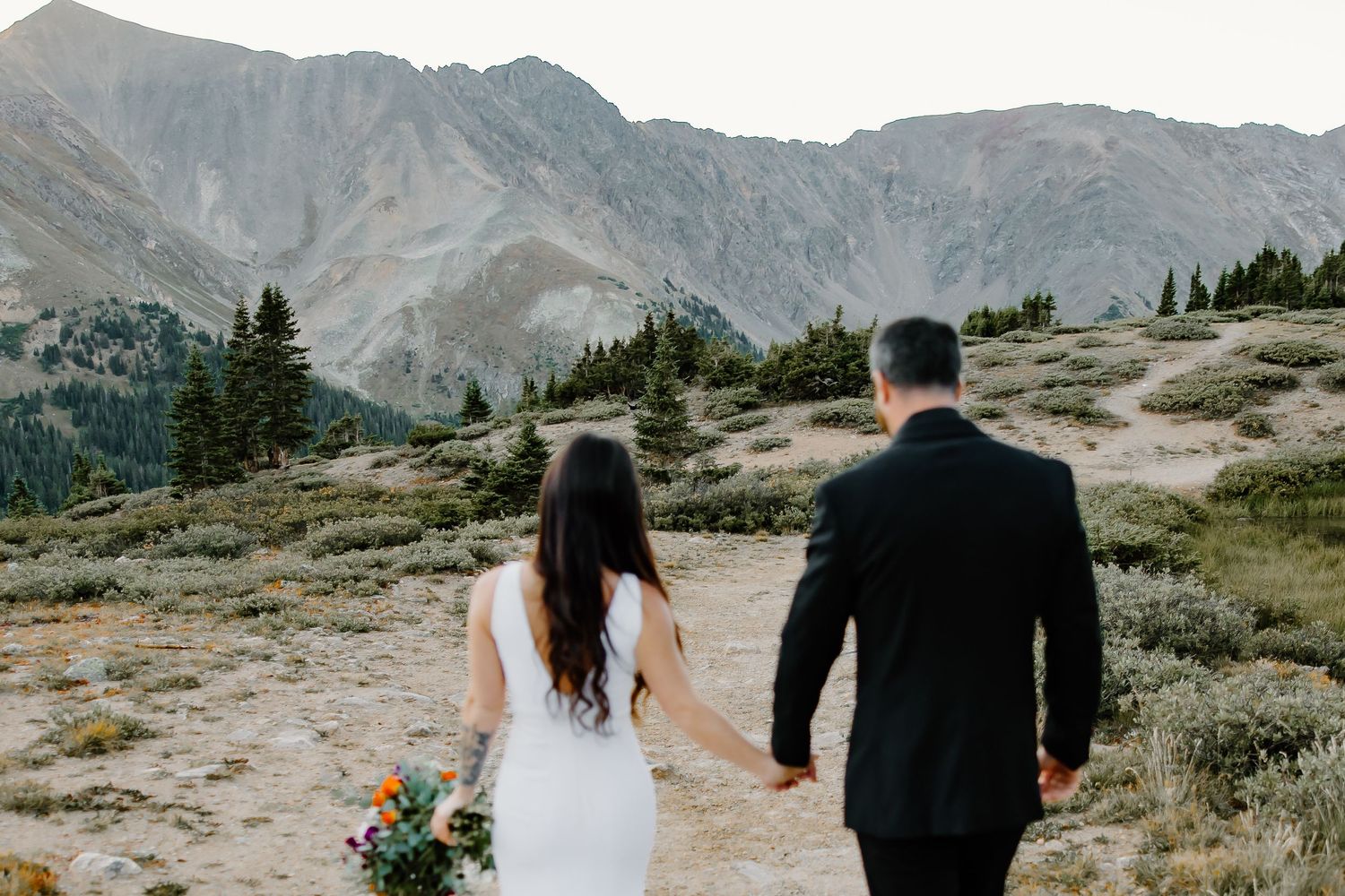 Dramatic mountain range backdrop for outdoor wedding ceremony.
