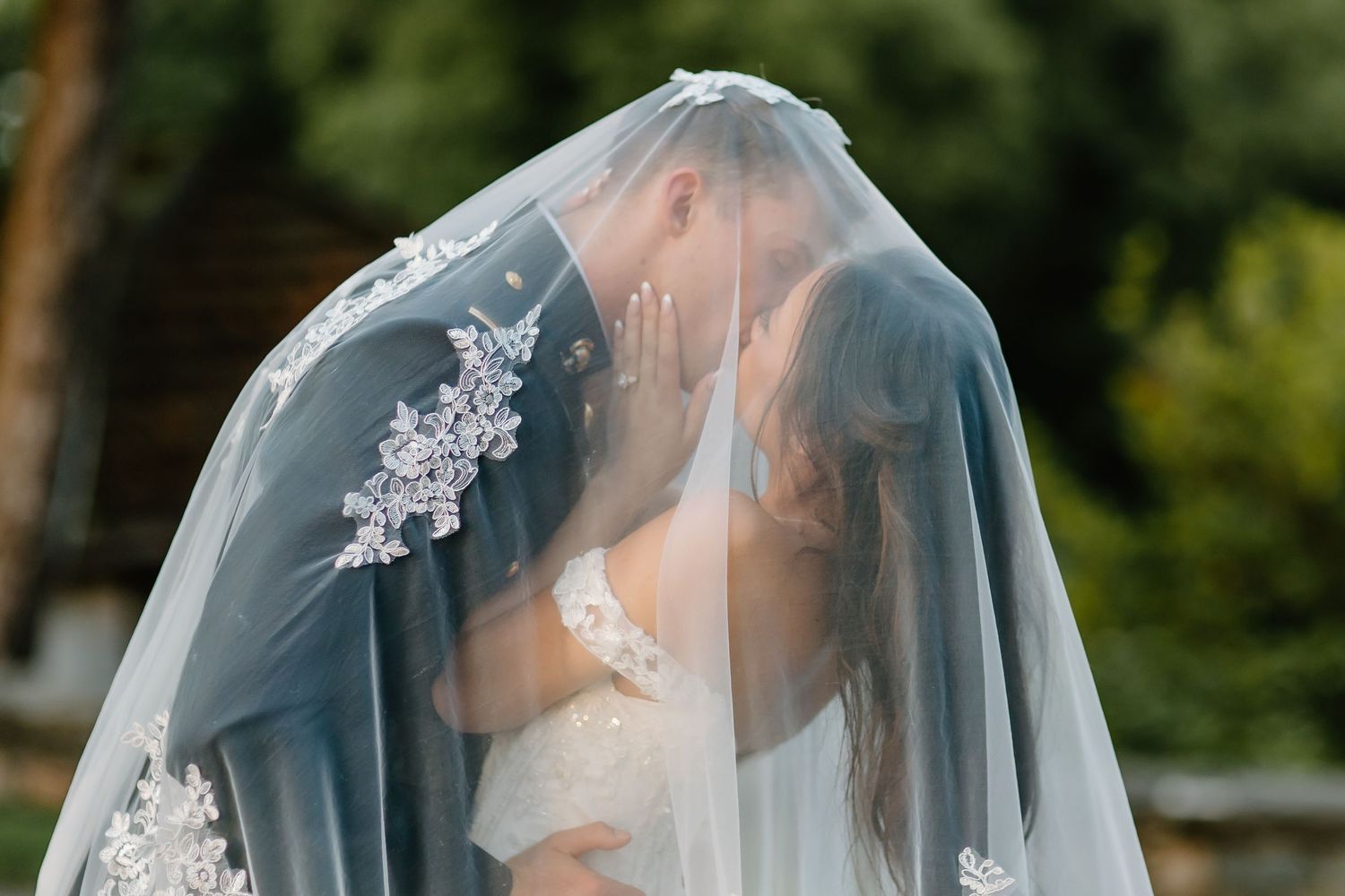 Delicate bridal veil details with lace embellishments in soft lighting.