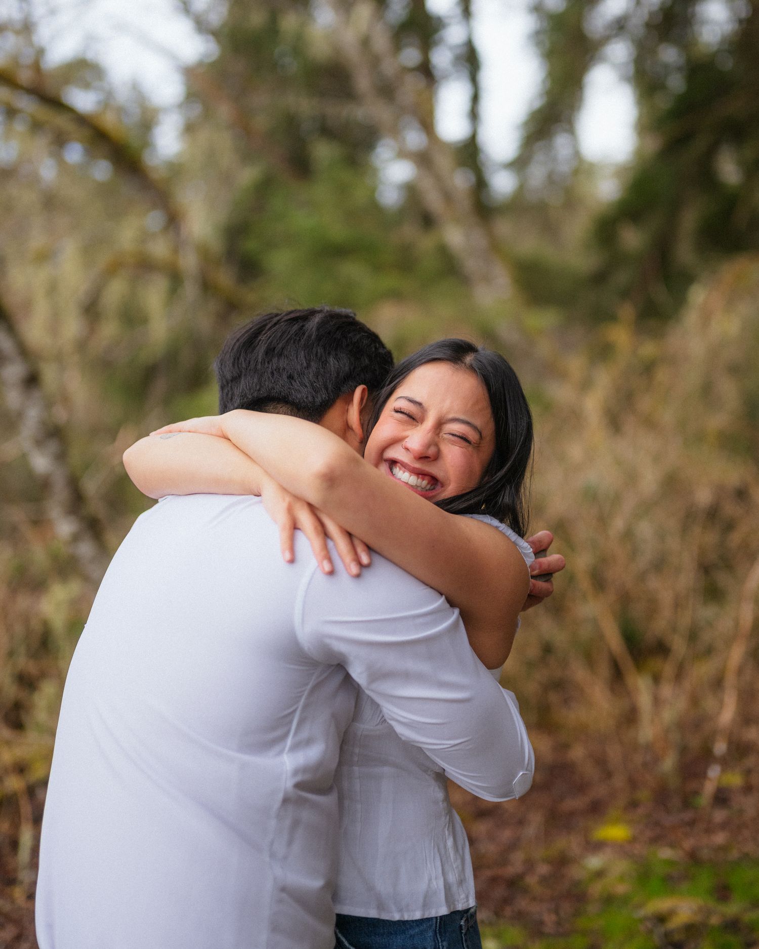 A playful sequence of hugs and embraces captured outdoors against a natural backdrop.