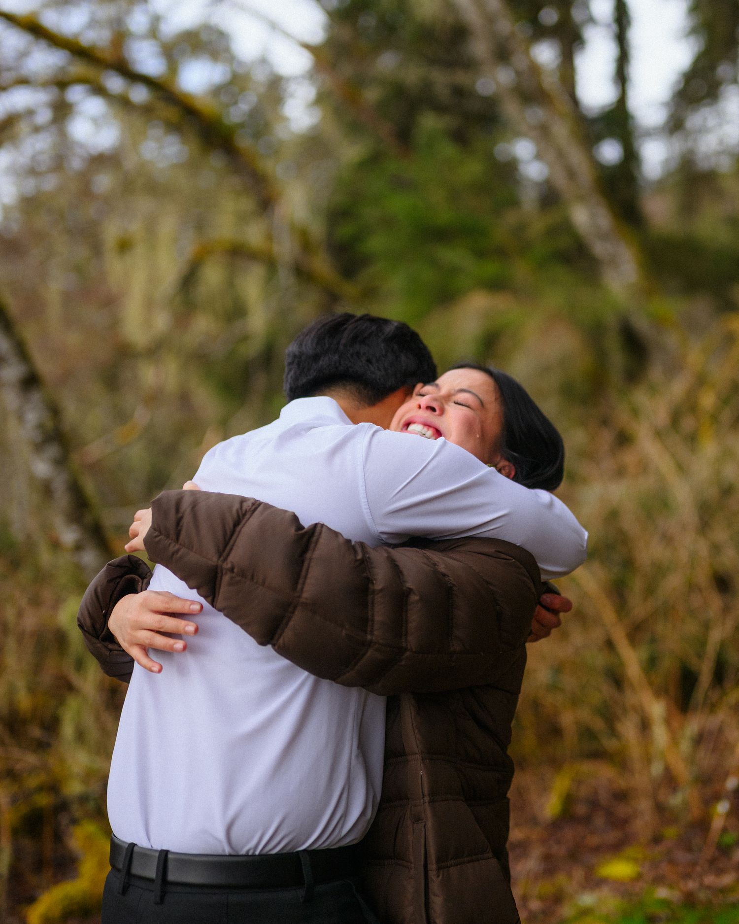 A series of warm embraces captured in a natural outdoor setting with trees in the background.