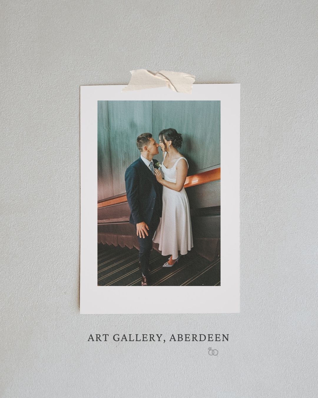 A romantic couple shares an intimate moment at the Art Gallery in Aberdeen, captured in a vintage-style photograph.