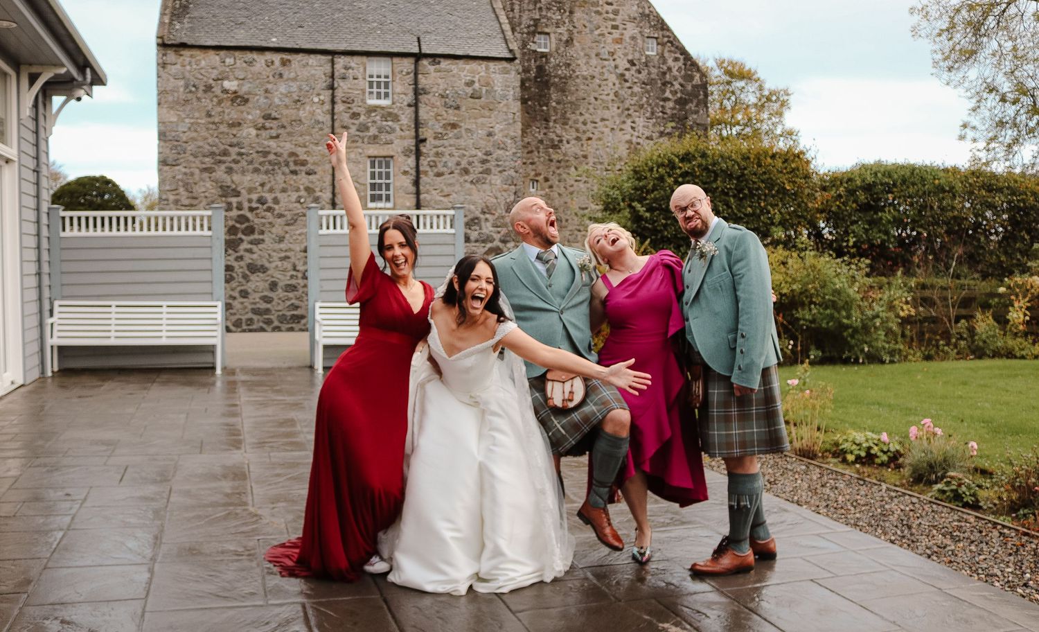 A series of candid wedding moments captured at a stone building venue with outdoor garden views.