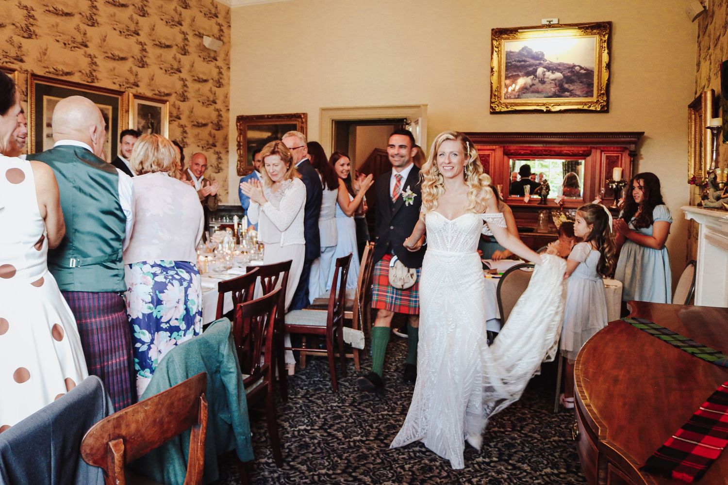 Wedding celebration with guests gathered in a traditional rustic venue with stone walls and elegant decor.