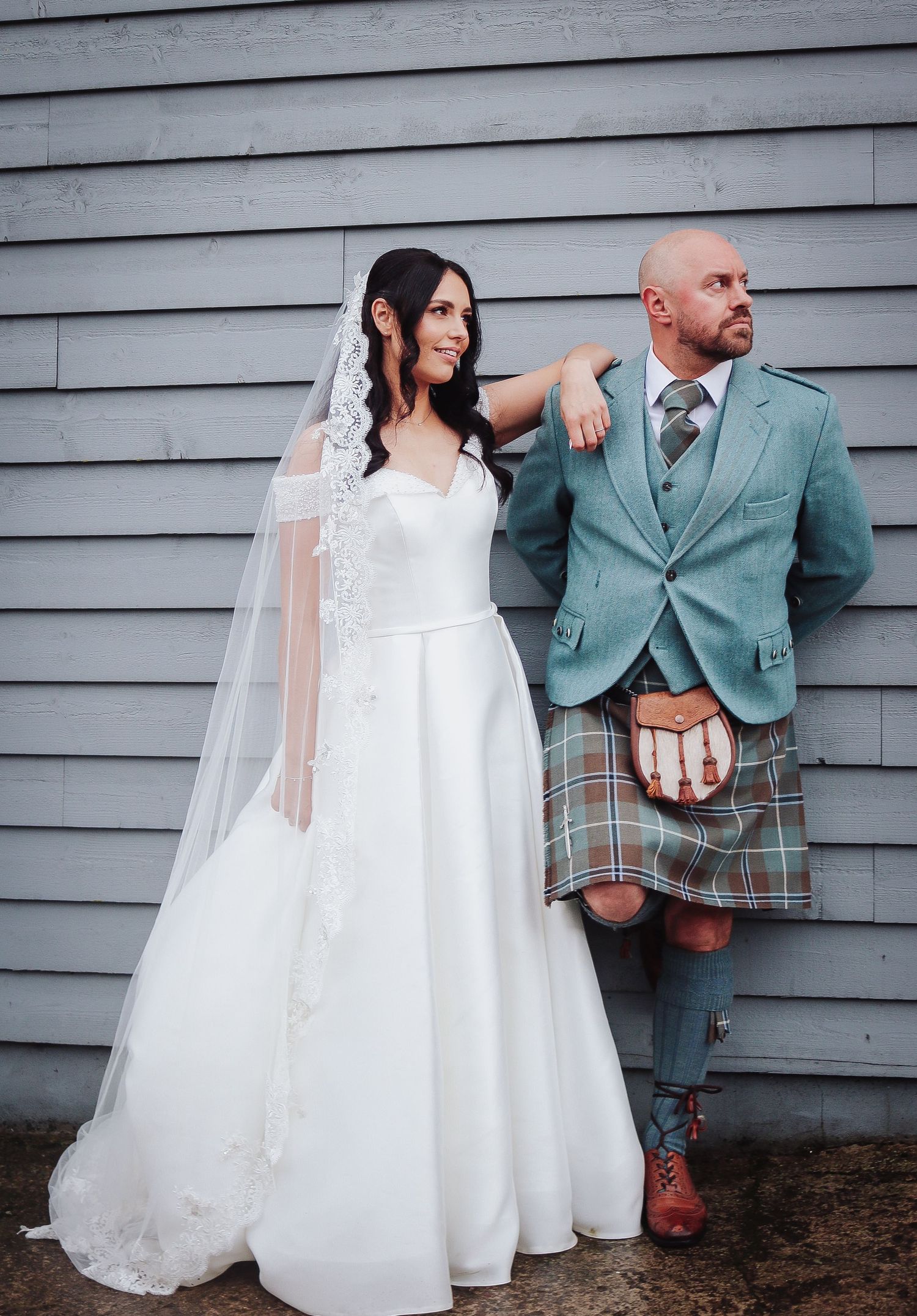 Wedding couple at Barra Castle Aberdeenshire standing against a wall