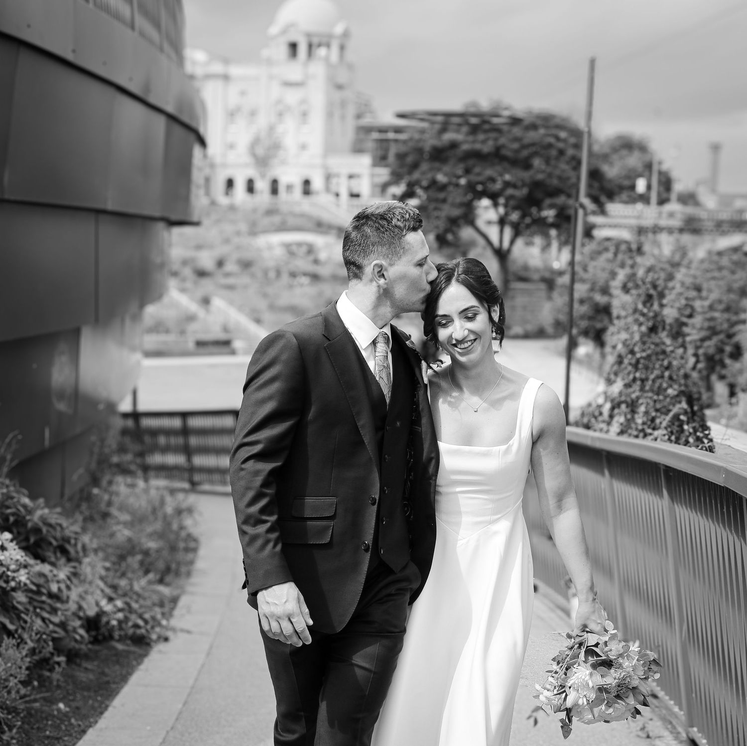 in Aberdeen city Black and white wedding photos showing romantic moments between newlyweds on a balcony with city views.