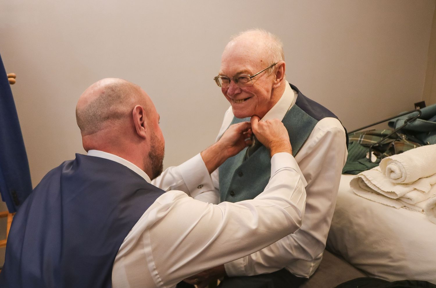 A medical professional performs a chiropractic adjustment on a patient lying on an examination table.