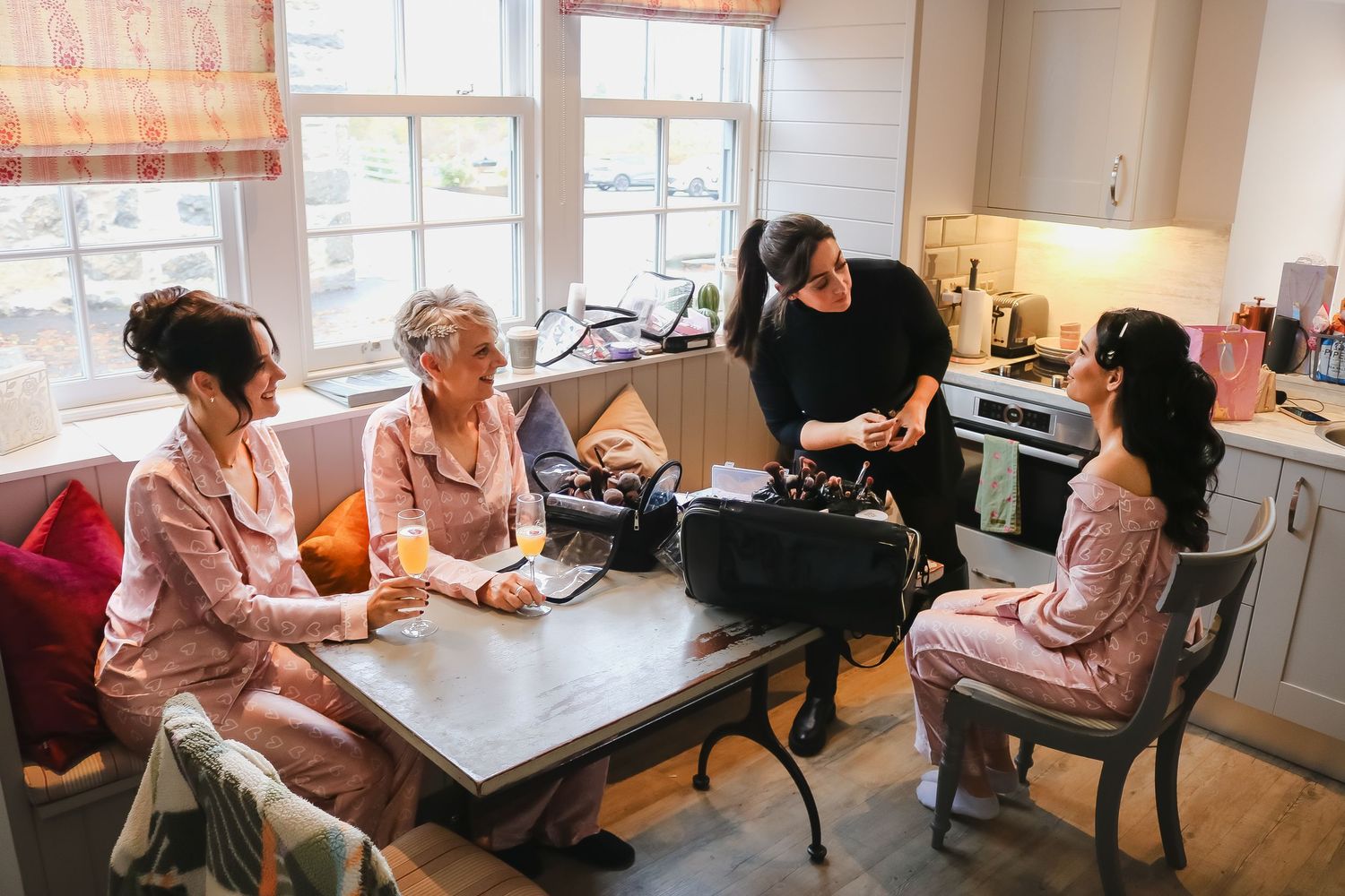 Elderly residents gather around tables in a nursing home common area engaging in activities and socializing.