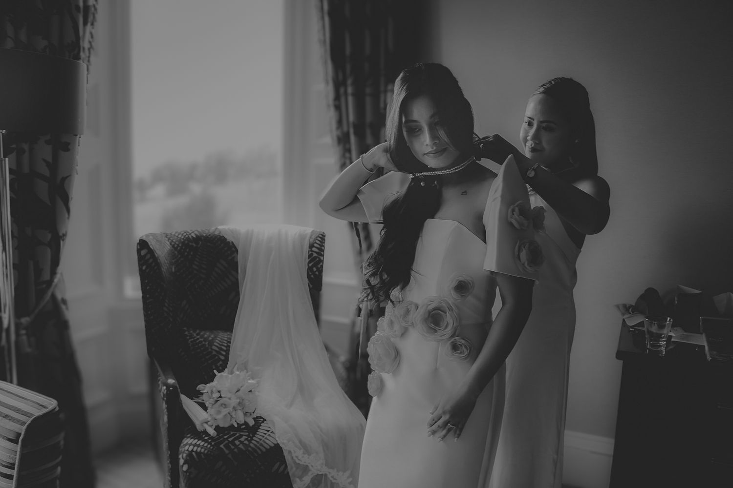 Black and white collage of wedding moments showing candid interactions and emotions during a celebration.