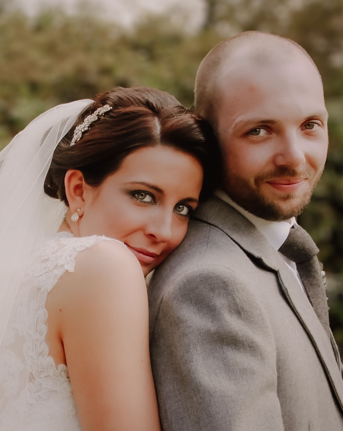 A romantic wedding photo series showing close-up shots of a couple in sepia tones.