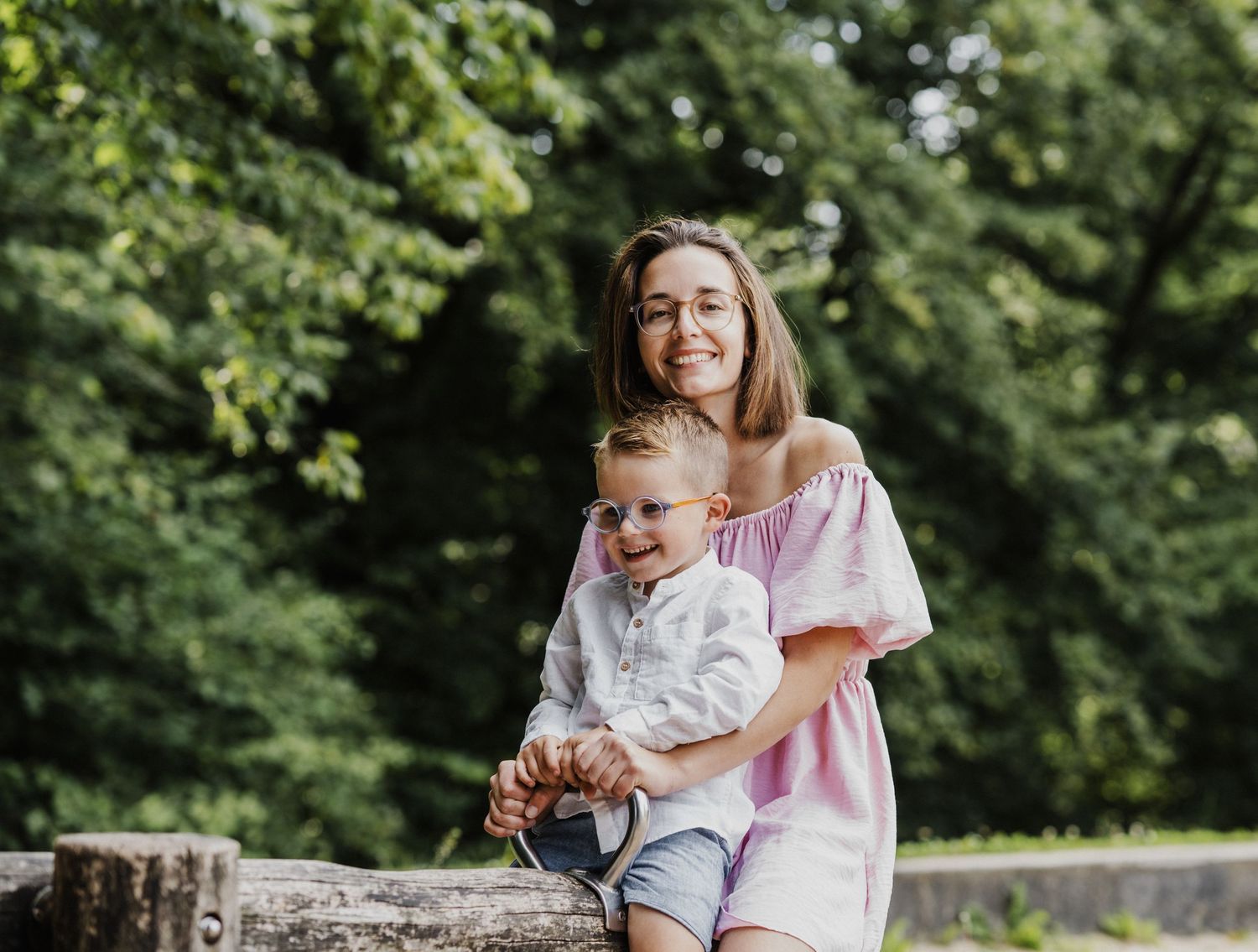 A series of tender moments between parent and child outdoors surrounded by green foliage.