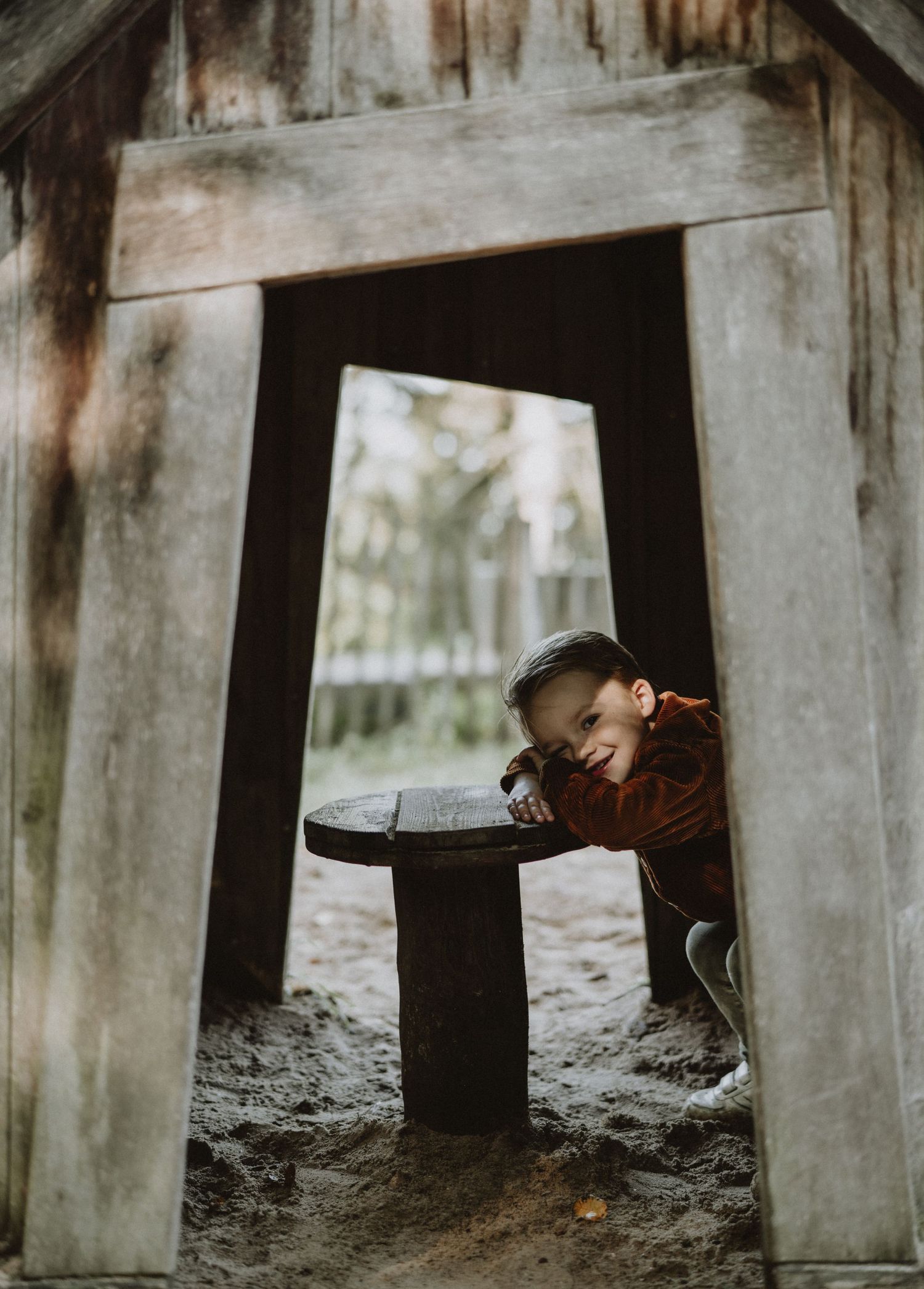 Artistic photos under wooden bridge structure showing intimate family moments.