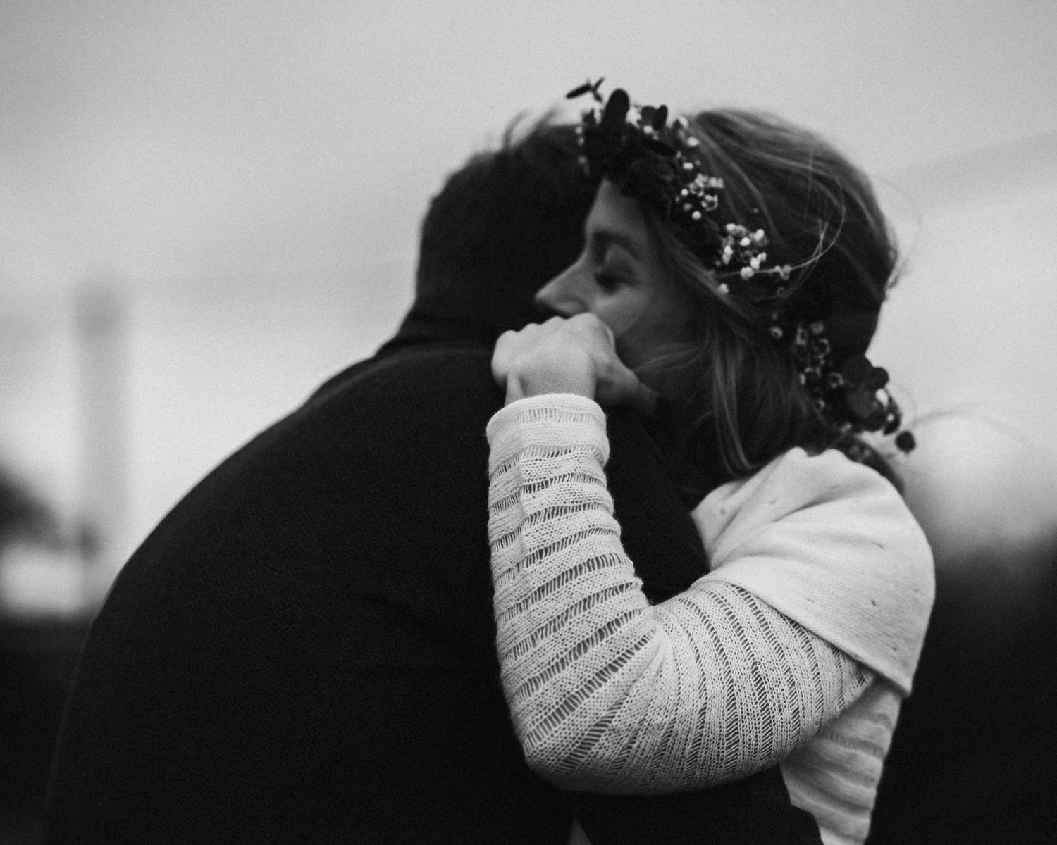 Series of black and white intimate wedding portraits showing emotional embraces.