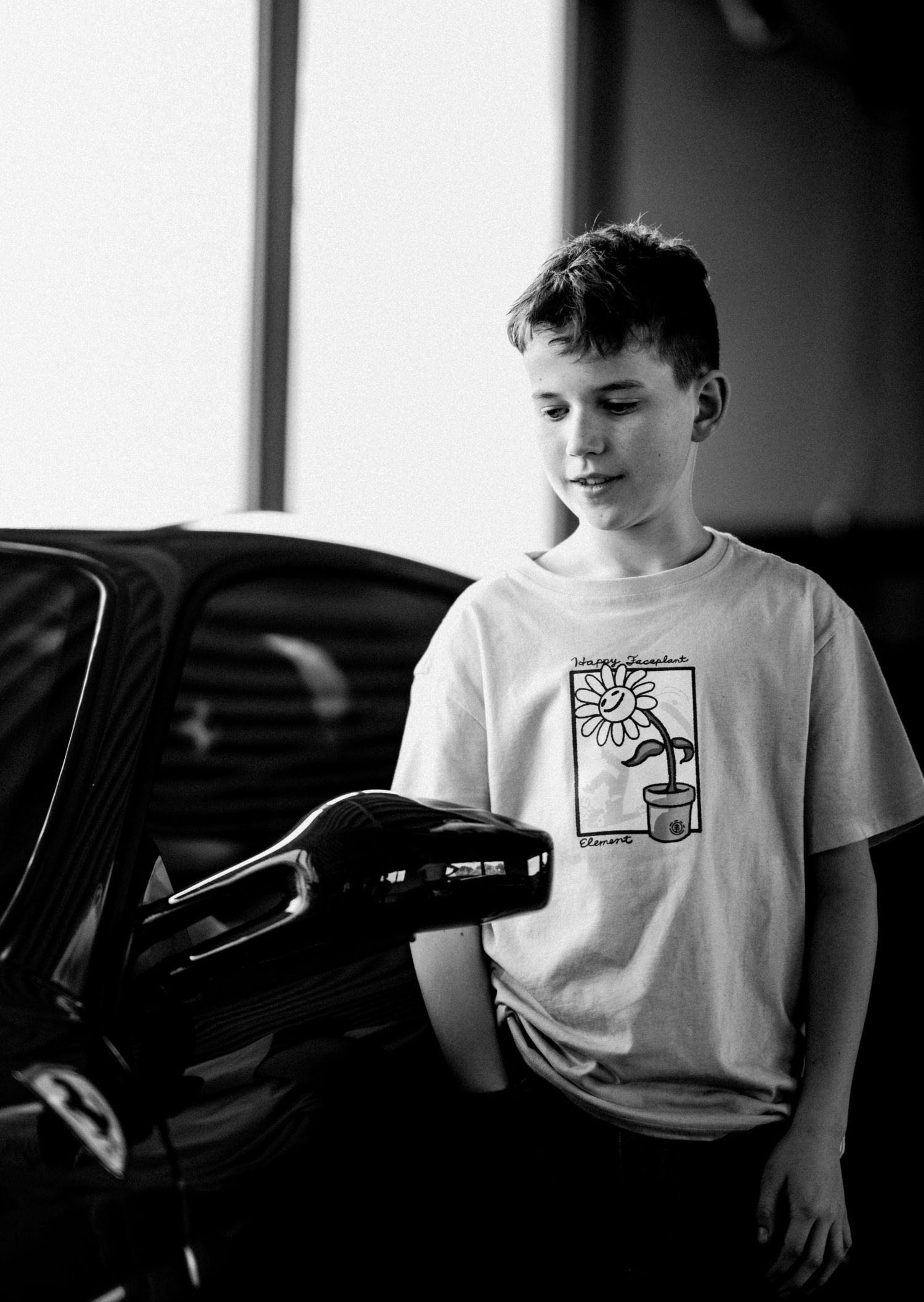 Black and white portrait series showing someone wearing a graphic t-shirt.