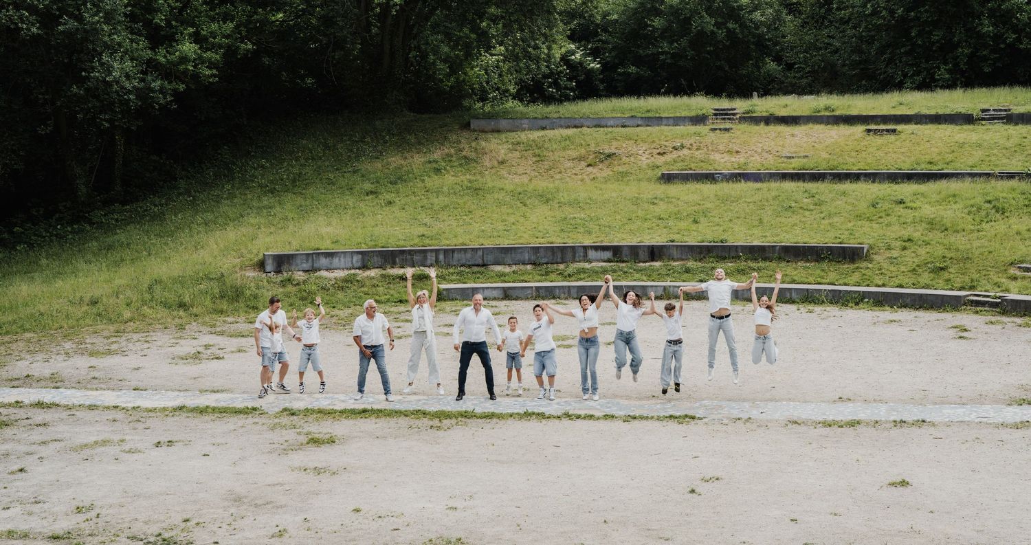 Wide panoramic view of people gathered in an outdoor recreational area.