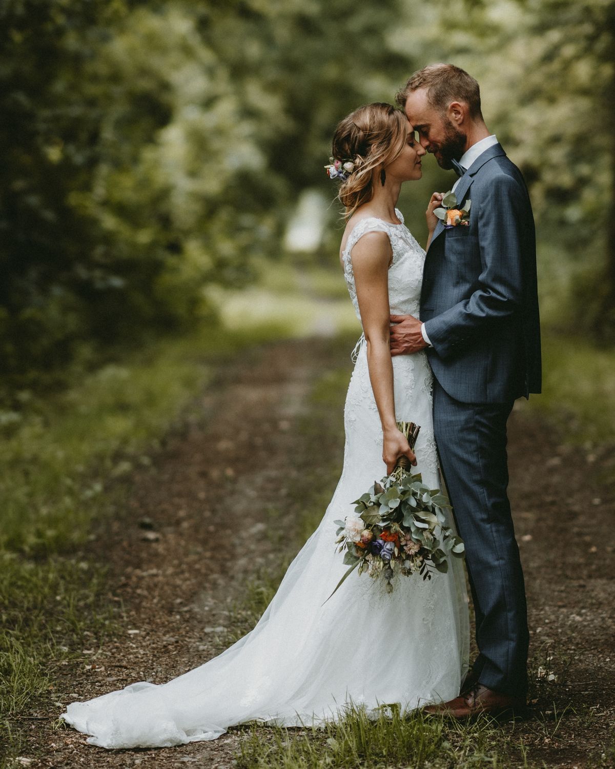 Romantic woodland path setting with natural greenery backdrop.