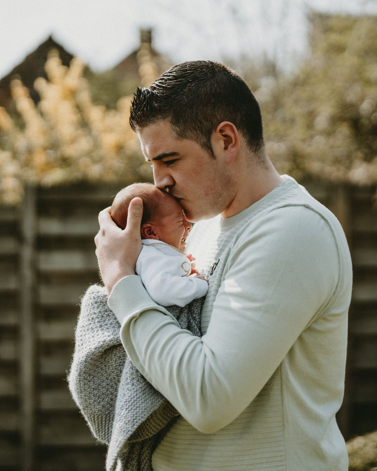 Intimate close-up moments between parent and baby in soft winter light.