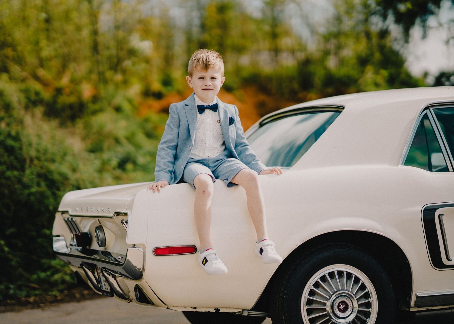 Classic car photoshoot featuring vintage automobile details and natural outdoor setting.