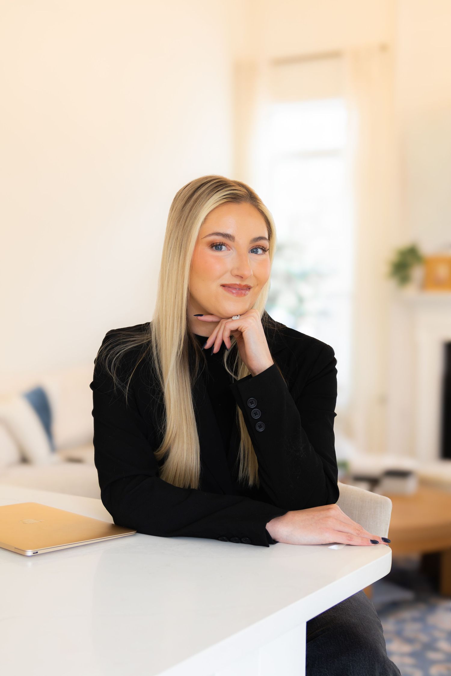 Professional headshot in a bright modern office interior with soft natural lighting.