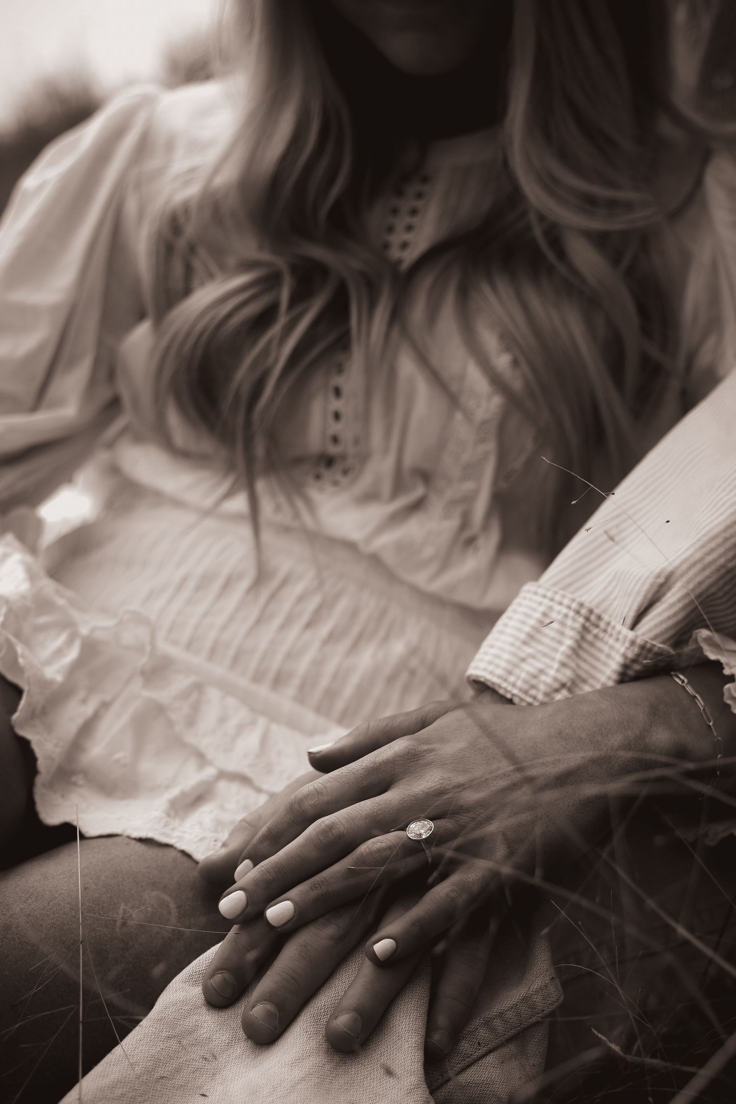 Artistic black and white close-up shots focusing on hands and vintage-style dress details.