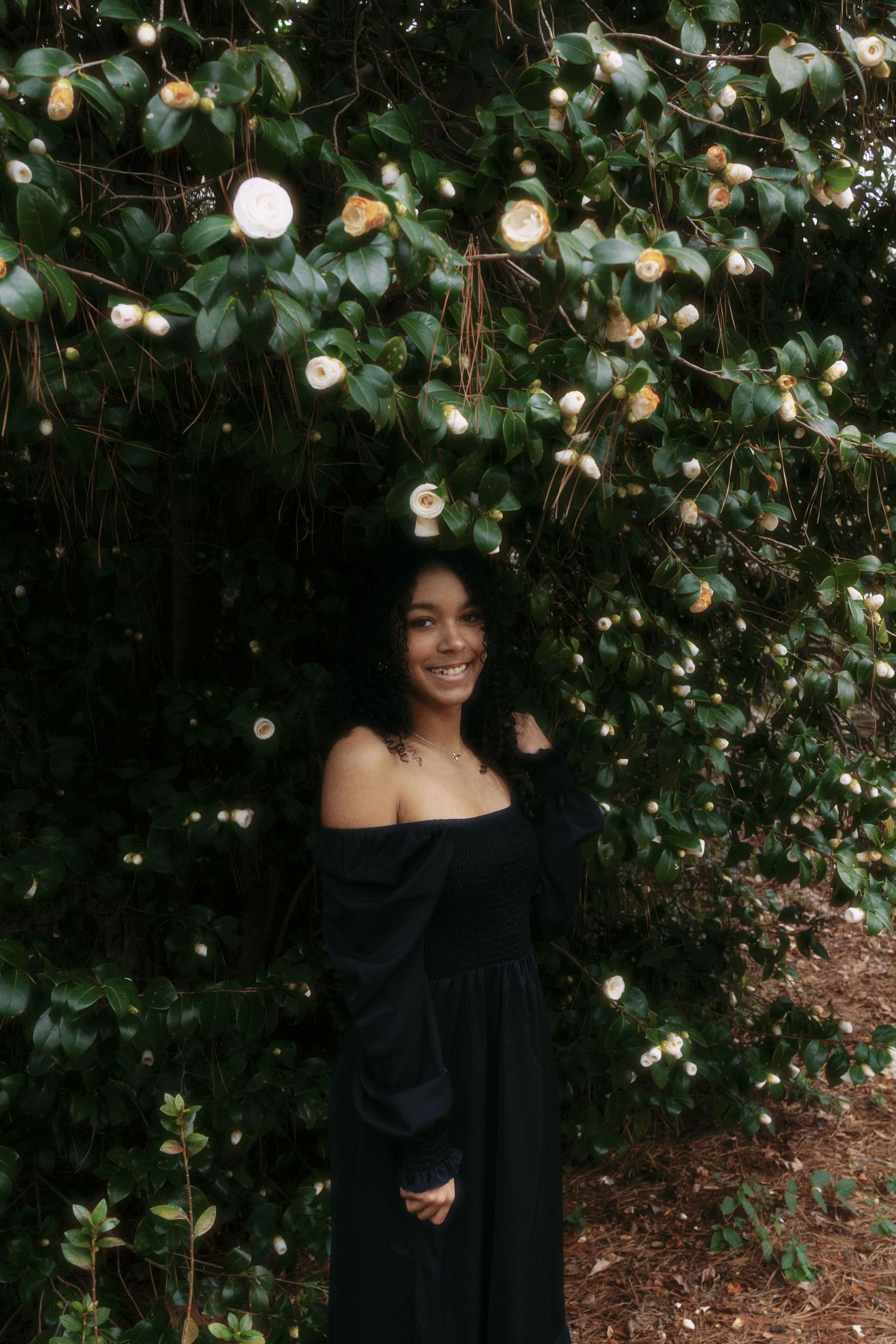 Portrait sequence under twinkling lights and greenery in garden setting.