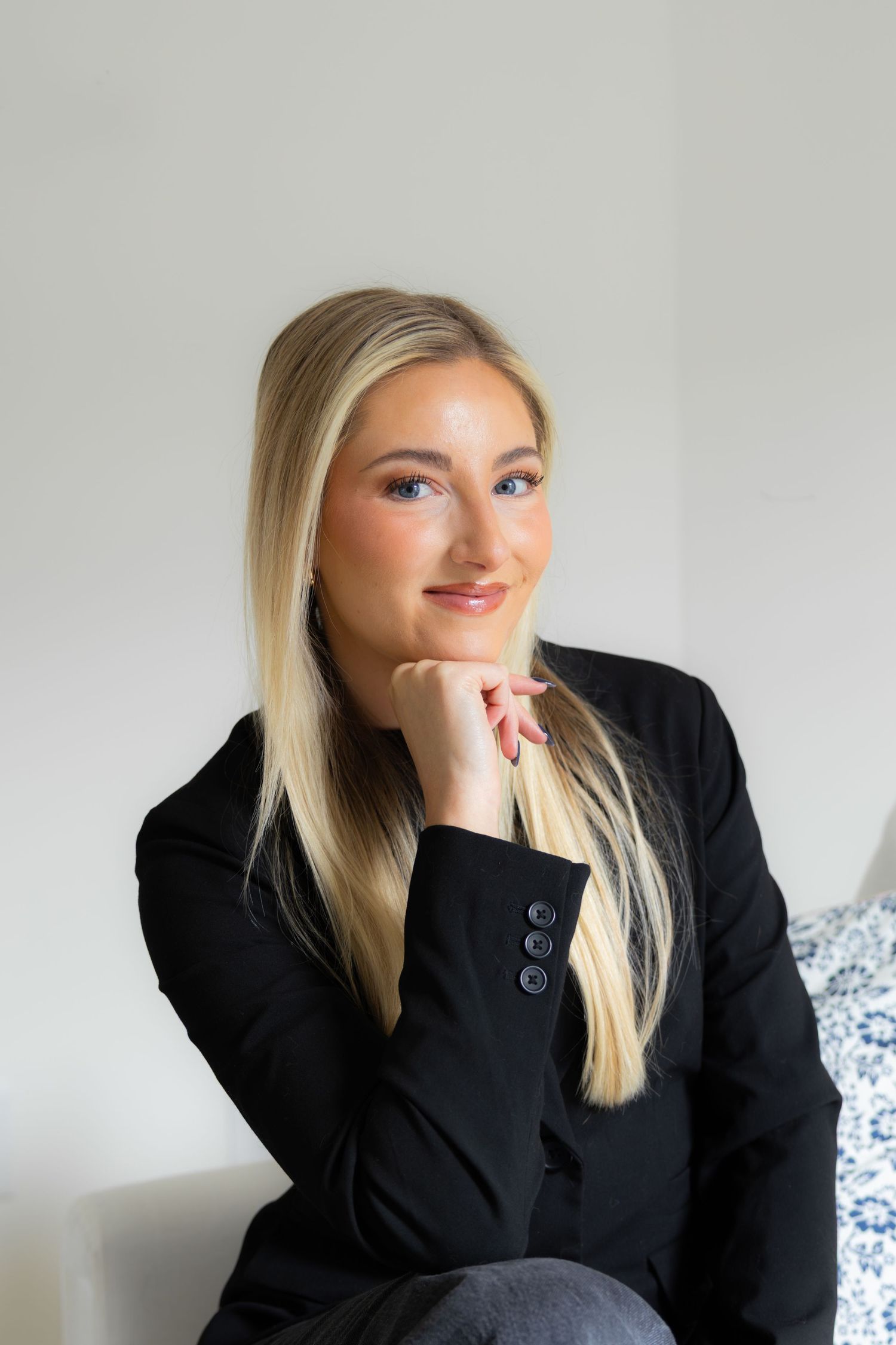 Series of portraits showing a person in black blazer making expressive faces against white background.