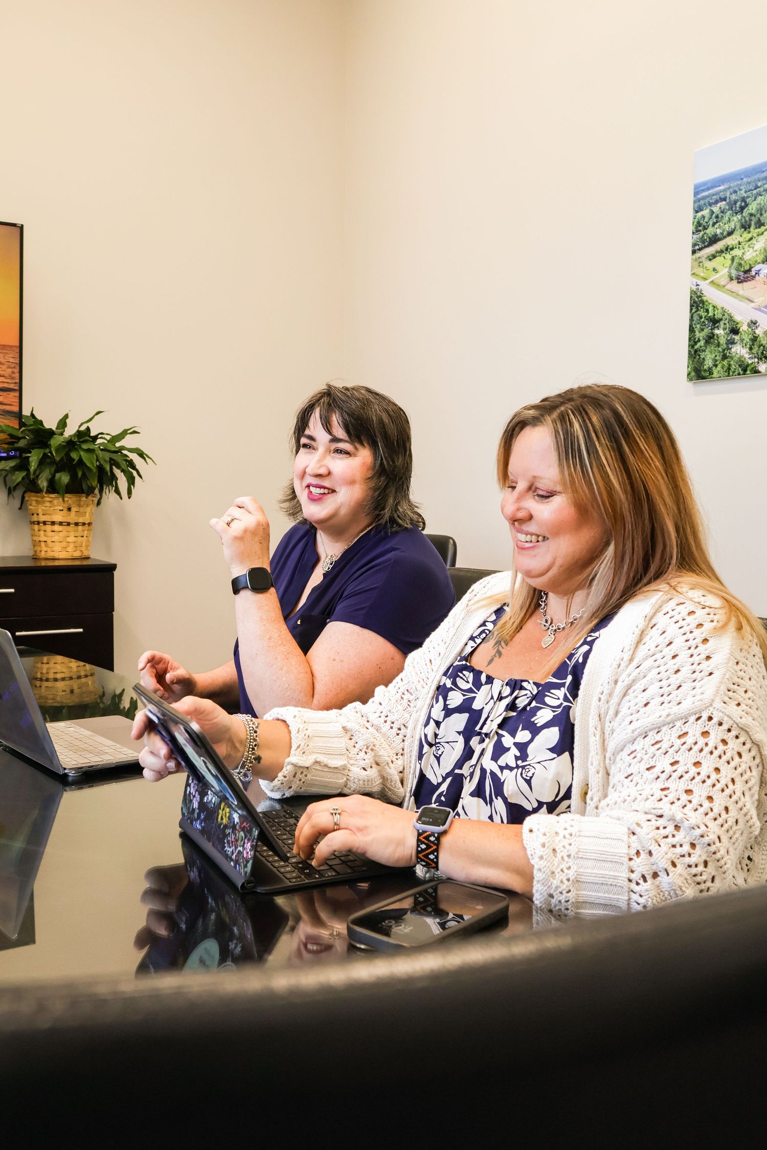 Group gathered around a conference table in an office setting.