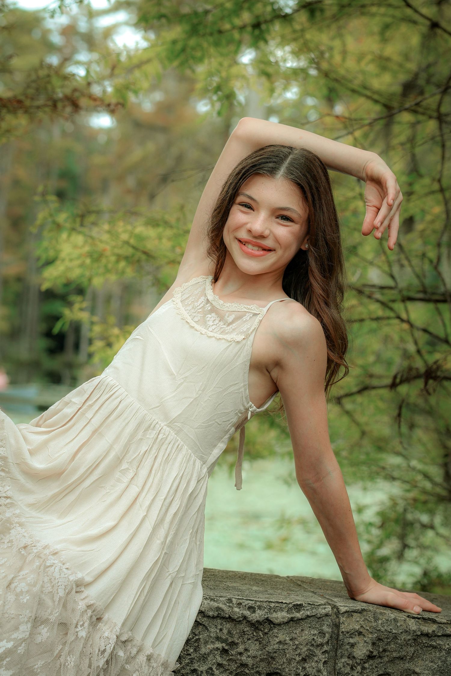 A white sundress photoshoot in a lush garden setting with soft natural lighting.