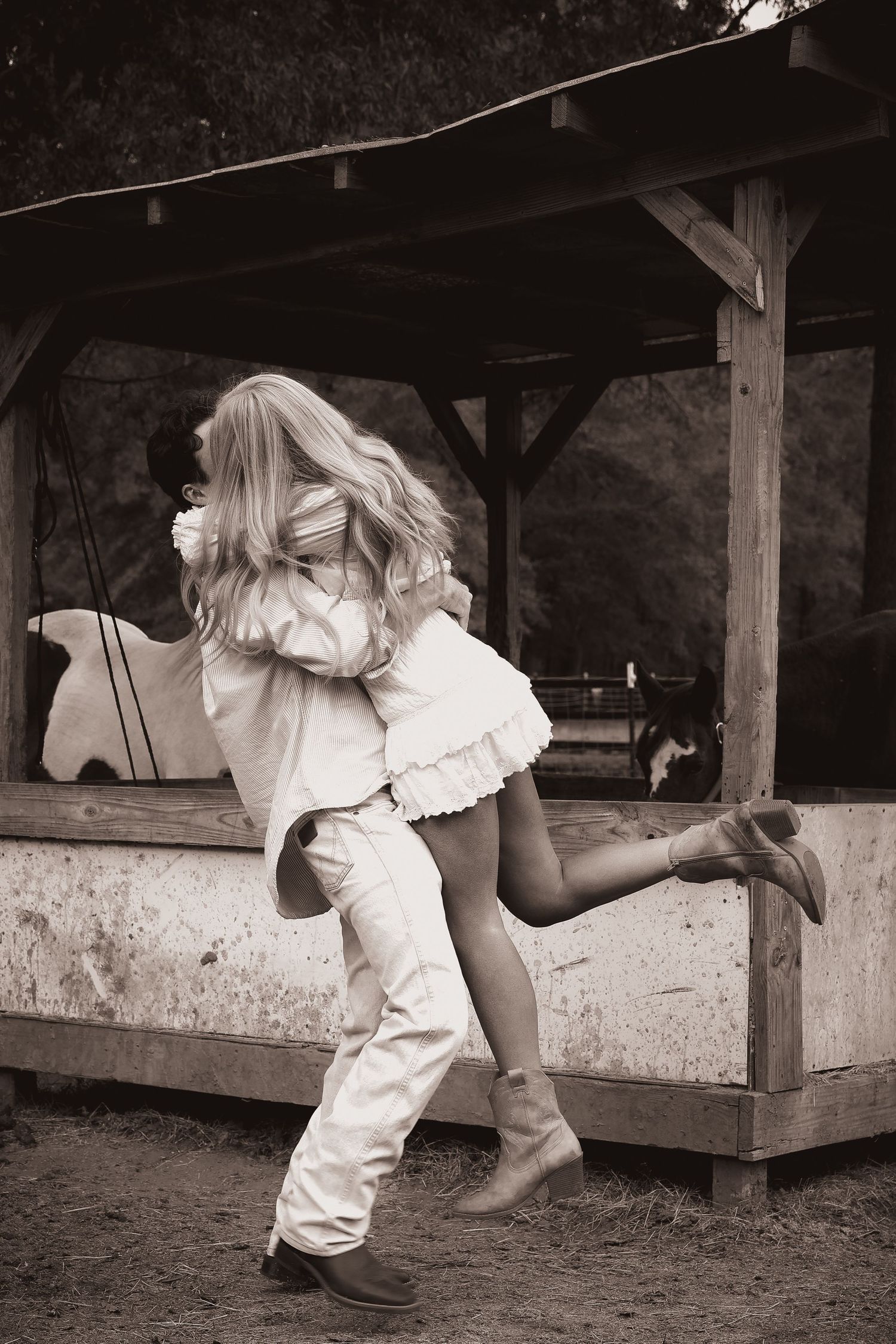 A playful sequence of someone crawling under white wooden benches in a rustic setting.